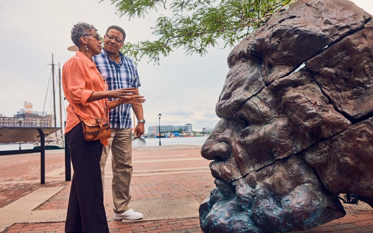 2 people looking at a sculpture
