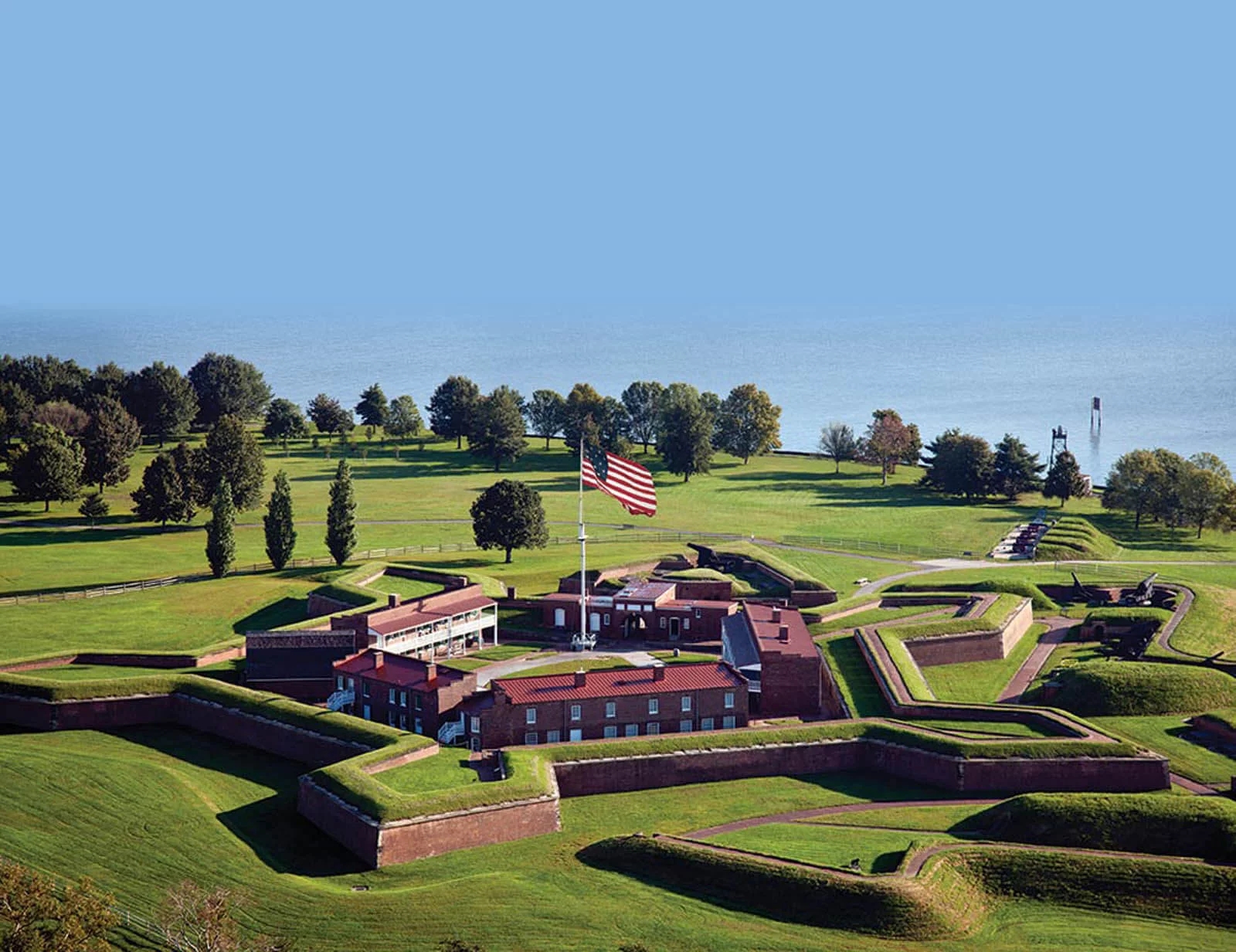 A large American flag flies from the center of Fort McHenry in Baltimore.