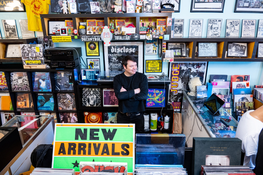 Man poses in a record store