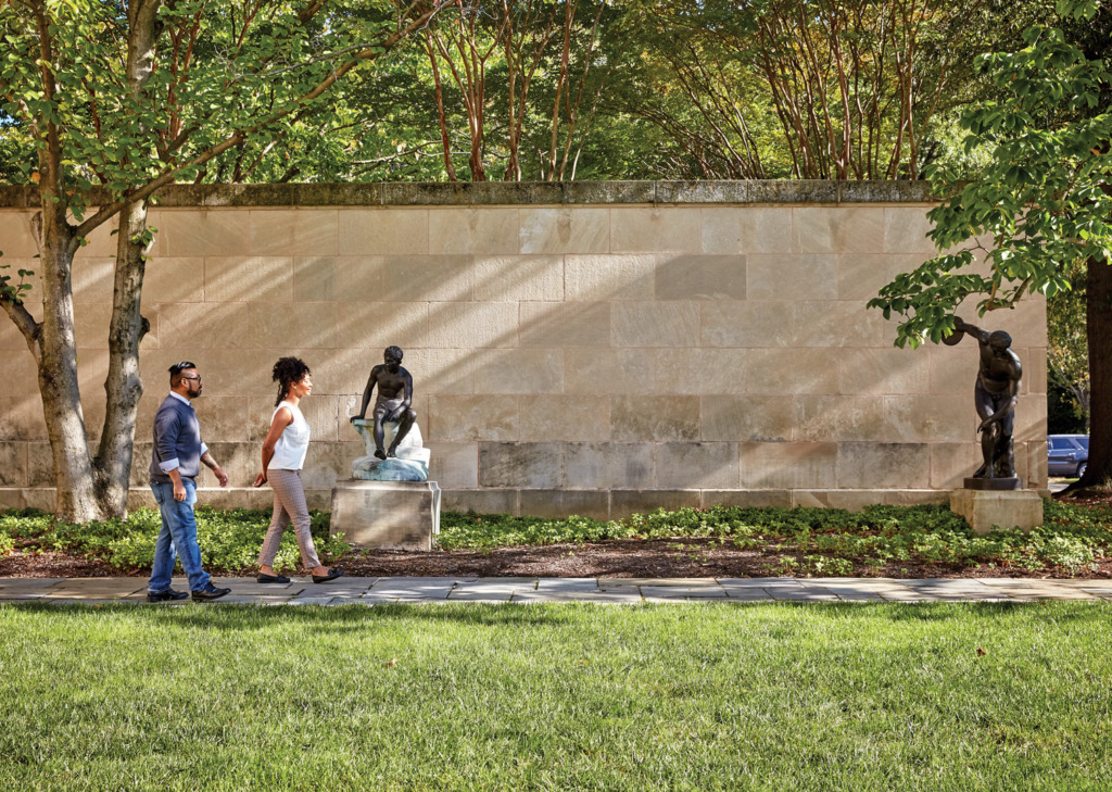 A couple walking in the sculpture garden at the Baltimore Museum or Art.
