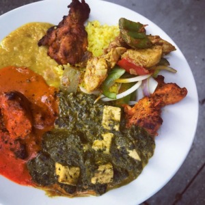 Saag paneer and tandoori chicken on a plate