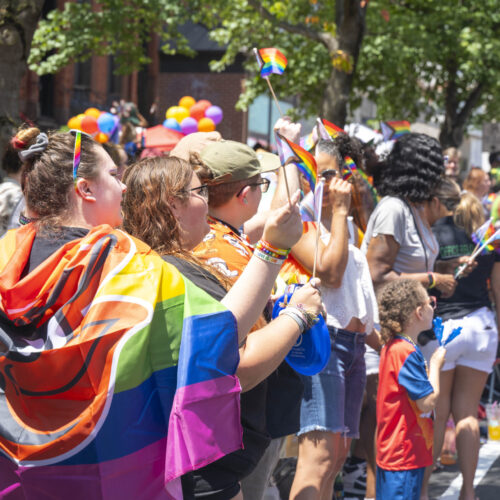 A colorful crowd in rainbow clothing