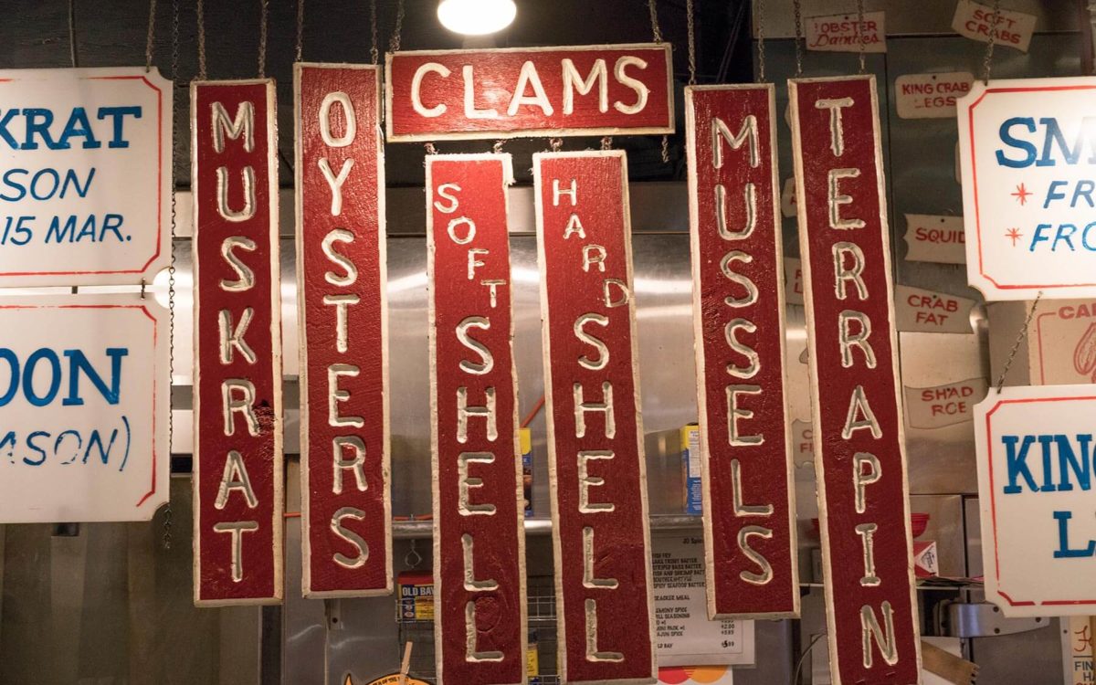 Red and white hand crafted vintage signage at Faidleys in Lexington Market in Baltimore.