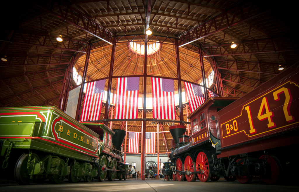 Two B&O trains inside the B&O Railroad Museum facing into the center museum chamber.
