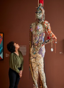 A woman admires a bejeweled statue at the American Visionary Art Museum 