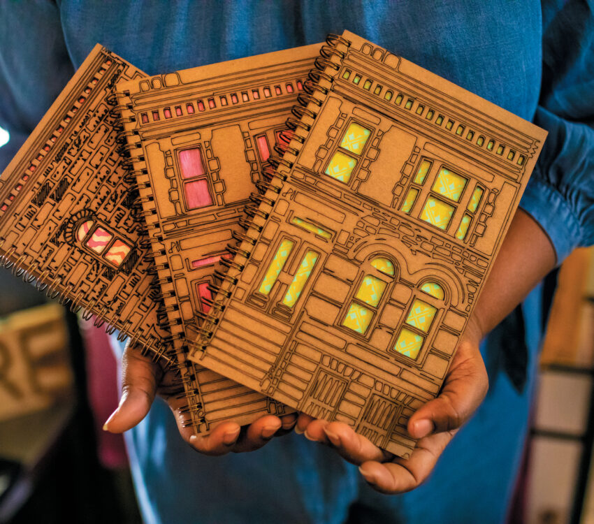Woman holds brown journals