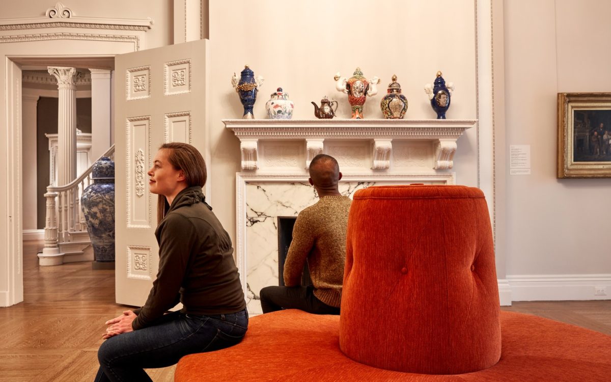 A man and woman admire pottery at the Walters Art Museum