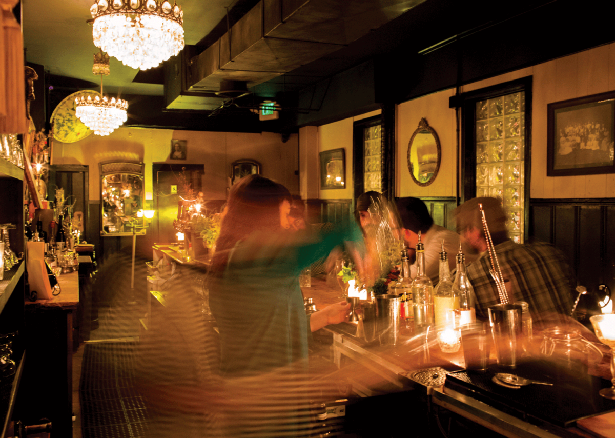 A blurry shot of a bartender making drinks